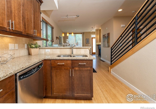 5060 Pierre St Unit E, Boulder, CO 80304 - kitchen featuring stainless steel dishwasher, a peninsula, backsplash, light wood-style floors, and hanging light fixtures