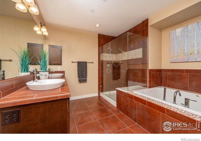 5060 Pierre St Unit E, Boulder, CO 80304 - bathroom with double vanity, a shower stall, a bath, and tile patterned floors