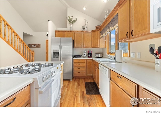 1437 Raven Cir Unit A, Estes Park, CO 80517 - kitchen with white appliances, light wood finished floors, vaulted ceiling, light countertops, and recessed lighting