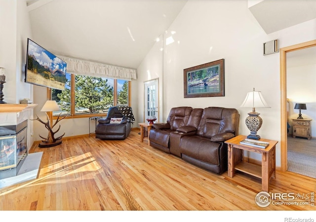 1437 Raven Cir Unit A, Estes Park, CO 80517 - living area with wood finished floors, high vaulted ceiling, and a fireplace