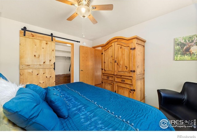 1437 Raven Cir Unit A, Estes Park, CO 80517 - bedroom featuring a barn door, a ceiling fan, and a walk in closet
