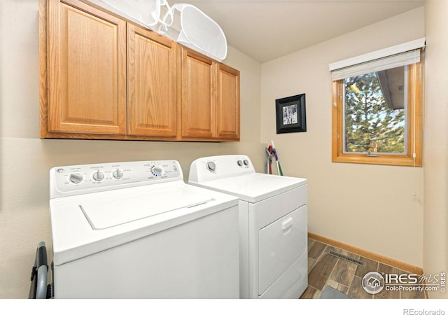 1437 Raven Cir Unit A, Estes Park, CO 80517 - laundry room featuring washer and clothes dryer, dark wood finished floors, and cabinet space