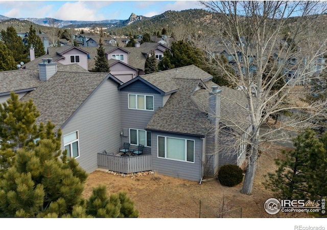 1437 Raven Cir Unit A, Estes Park, CO 80517 - view of home's exterior featuring roof with shingles, a deck with mountain view, and a residential view