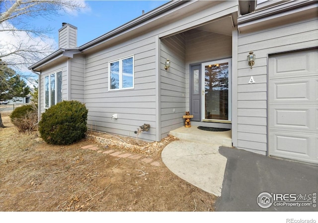 1437 Raven Cir Unit A, Estes Park, CO 80517 - view of exterior entry featuring a chimney