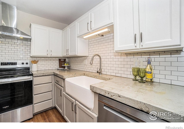 705 E Drake Rd Unit 45, Fort Collins, CO 80525 - kitchen featuring stainless steel electric range, wall chimney exhaust hood, white cabinets, backsplash, and dark wood-style flooring