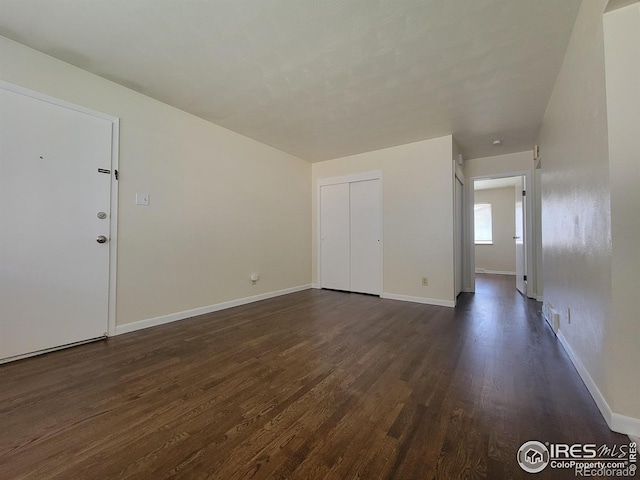 117 Valentine Ln, Longmont, CO 80501 - unfurnished living room with dark wood-style flooring and baseboards