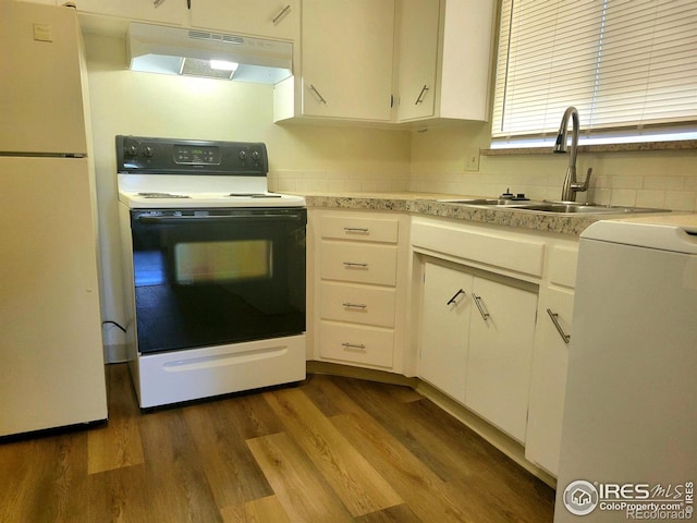 117 Valentine Ln, Longmont, CO 80501 - kitchen featuring white appliances, under cabinet range hood, light countertops, white cabinets, and dark wood-type flooring