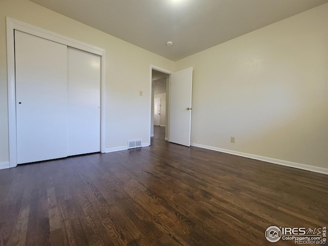 117 Valentine Ln, Longmont, CO 80501 - unfurnished bedroom featuring dark wood finished floors and a closet