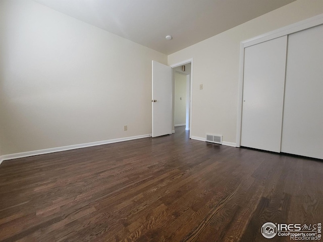 117 Valentine Ln, Longmont, CO 80501 - unfurnished bedroom with dark wood-style floors and a closet