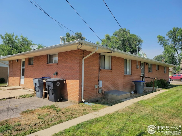 117 Valentine Ln, Longmont, CO 80501 - view of property exterior with brick siding and a yard