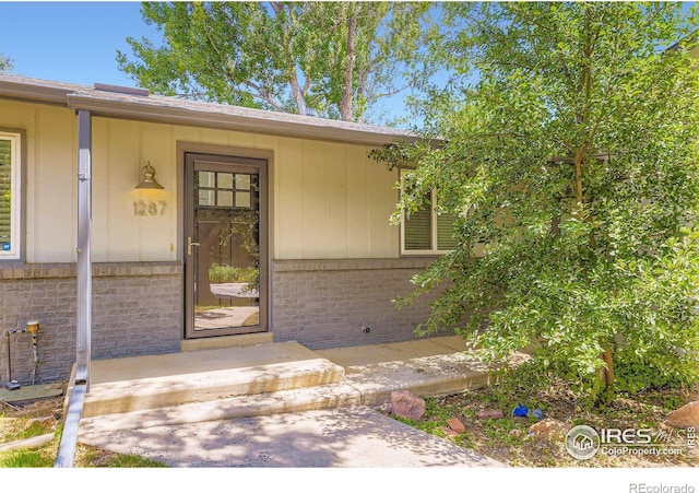 1287 Doric Dr, Lafayette, CO 80026 - doorway to property with brick siding