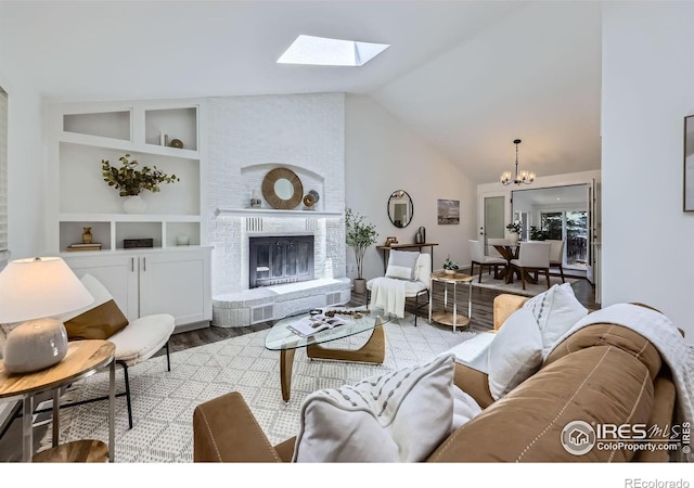 1287 Doric Dr, Lafayette, CO 80026 - living room featuring wood finished floors, a chandelier, a brick fireplace, lofted ceiling, and built in shelves