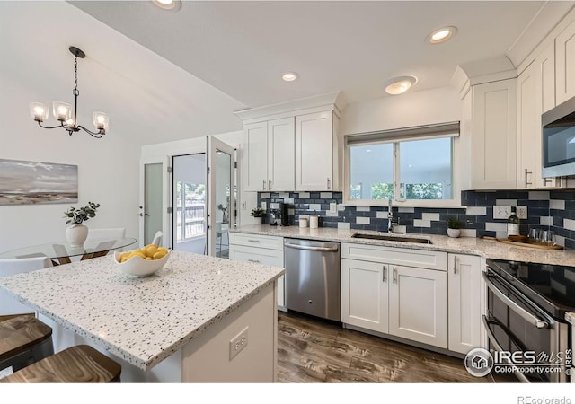 1287 Doric Dr, Lafayette, CO 80026 - kitchen with appliances with stainless steel finishes, plenty of natural light, backsplash, and recessed lighting