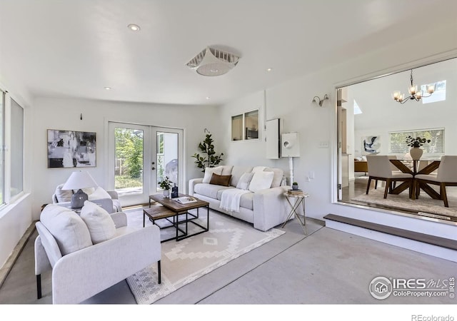 1287 Doric Dr, Lafayette, CO 80026 - living room featuring finished concrete floors, a chandelier, french doors, and recessed lighting