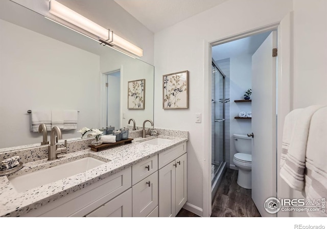 1287 Doric Dr, Lafayette, CO 80026 - bathroom with wood finished floors, double vanity, and a shower stall