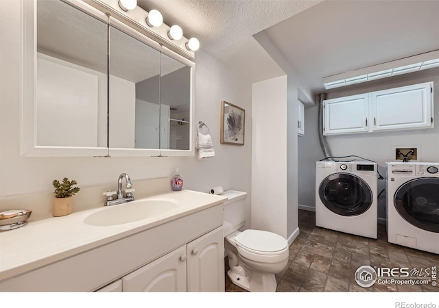 1287 Doric Dr, Lafayette, CO 80026 - full bathroom featuring washing machine and clothes dryer, stone finish floors, and vanity