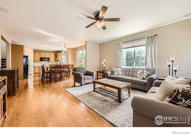 13065 Tamarac Pl, Thornton, CO 80602 - living area with light wood-style floors and a ceiling fan