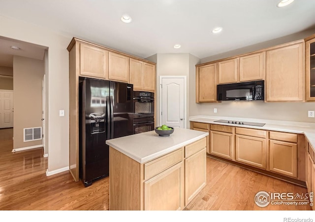 13065 Tamarac Pl, Thornton, CO 80602 - kitchen featuring black appliances, light brown cabinets, light wood-style floors, glass insert cabinets, and a center island