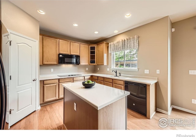 13065 Tamarac Pl, Thornton, CO 80602 - kitchen with black appliances, light wood-style floors, light countertops, glass insert cabinets, and a center island