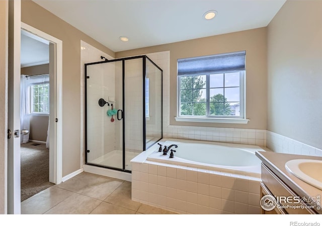 13065 Tamarac Pl, Thornton, CO 80602 - bathroom with a bath, a stall shower, tile patterned floors, vanity, and recessed lighting