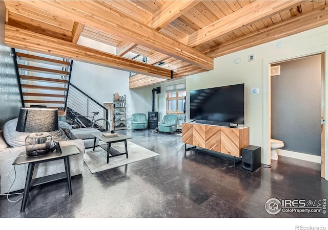 801 Confidence Dr Unit 16, Longmont, CO 80504 - living area with stairs, a wooden ceiling with exposed beams, a wood stove, and concrete flooring