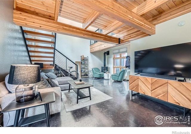 801 Confidence Dr Unit 16, Longmont, CO 80504 - living room with a wood ceiling with exposed beams, stairway, and a wood stove