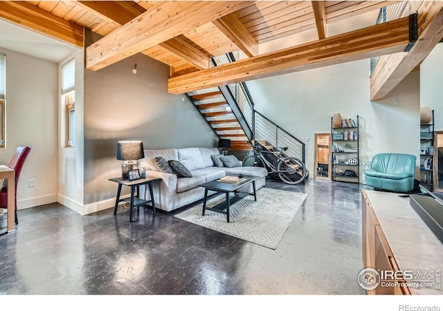801 Confidence Dr Unit 16, Longmont, CO 80504 - living room featuring a wooden ceiling with exposed beams, concrete floors, and stairs