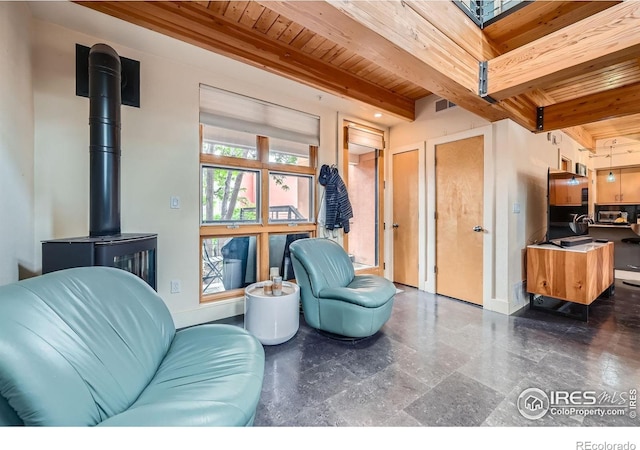 801 Confidence Dr Unit 16, Longmont, CO 80504 - living room featuring a wood ceiling with exposed beams and a wood stove