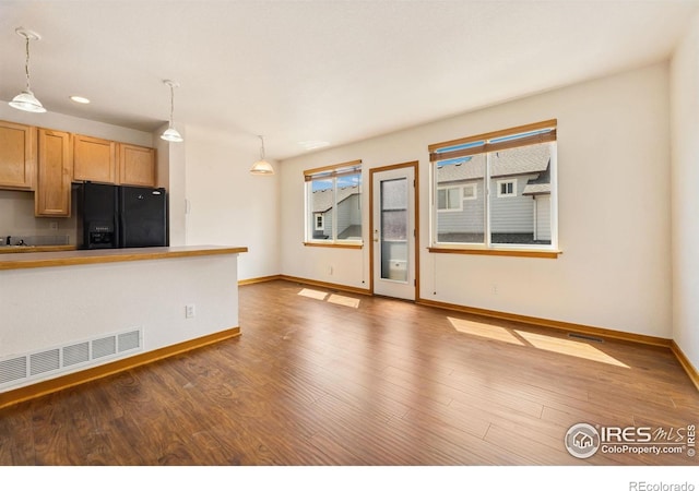 3686 Oakwood Dr, Longmont, CO 80503 - unfurnished living room featuring wood finished floors and recessed lighting