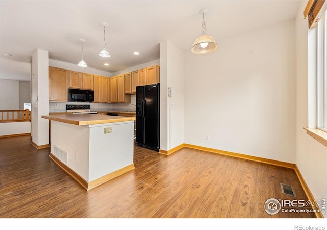 3686 Oakwood Dr, Longmont, CO 80503 - kitchen with black appliances, wood finished floors, light countertops, decorative light fixtures, and recessed lighting