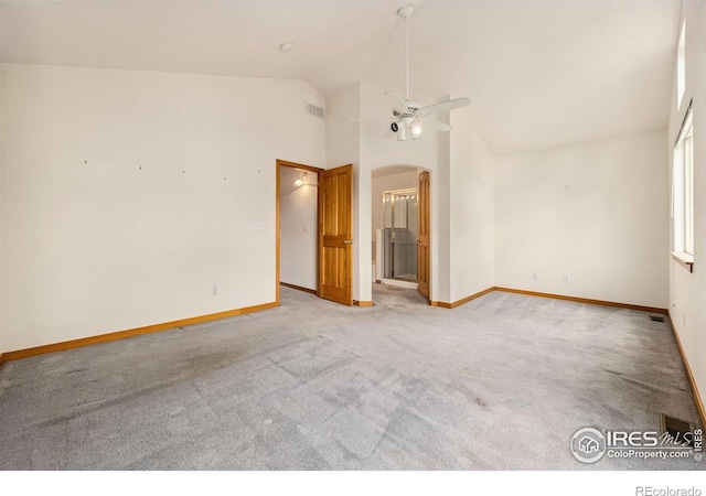 3686 Oakwood Dr, Longmont, CO 80503 - unfurnished room with light carpet, a ceiling fan, arched walkways, and high vaulted ceiling