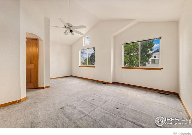 3686 Oakwood Dr, Longmont, CO 80503 - carpeted empty room with a ceiling fan, arched walkways, and high vaulted ceiling