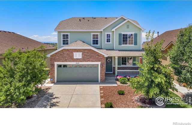 5049 S Ukraine St, Aurora, CO 80015 - traditional-style home with covered porch, driveway, a shingled roof, and a garage