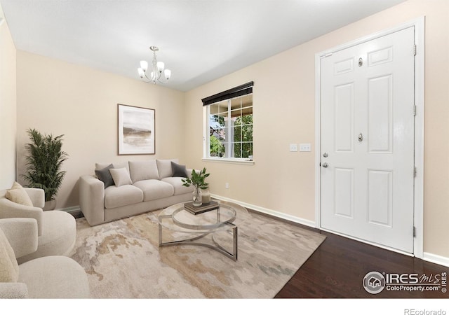 5049 S Ukraine St, Aurora, CO 80015 - living room featuring wood finished floors and a chandelier