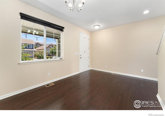 5049 S Ukraine St, Aurora, CO 80015 - empty room with a chandelier, dark wood-style floors, and recessed lighting