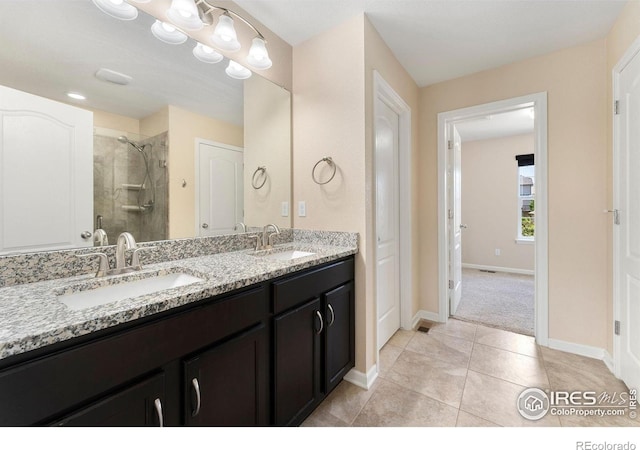 5049 S Ukraine St, Aurora, CO 80015 - bathroom with a stall shower, double vanity, and tile patterned floors