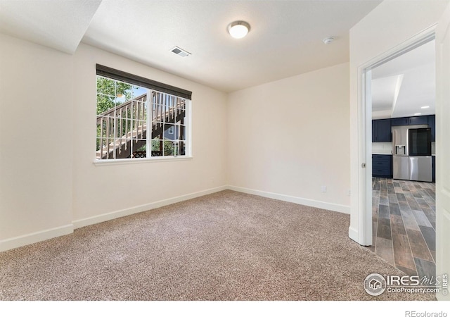5049 S Ukraine St, Aurora, CO 80015 - carpeted empty room featuring baseboards and a smoke detector