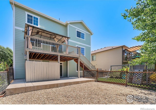 5049 S Ukraine St, Aurora, CO 80015 - back of house with a deck, a patio area, and stairs