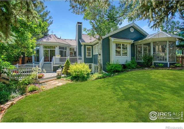 4471 Wellington Rd, Boulder, CO 80301 - view of front of house with a sunroom, a chimney, a wooden deck, and a front yard