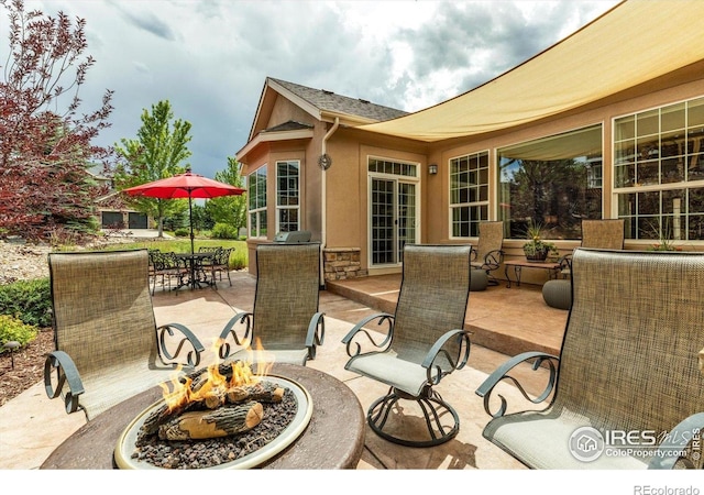 15002 Cosmos Way, Broomfield, CO 80023 - view of patio with a fire pit and outdoor dining space