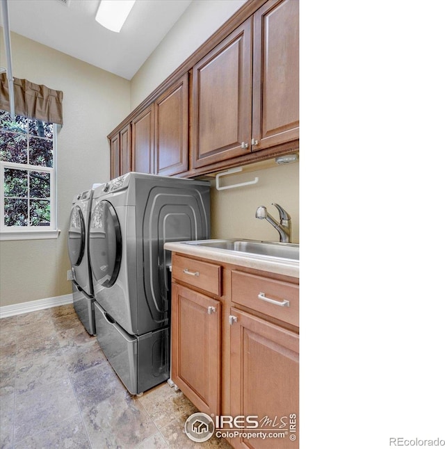 15002 Cosmos Way, Broomfield, CO 80023 - laundry room with washing machine and dryer, cabinet space, and stone finish floors