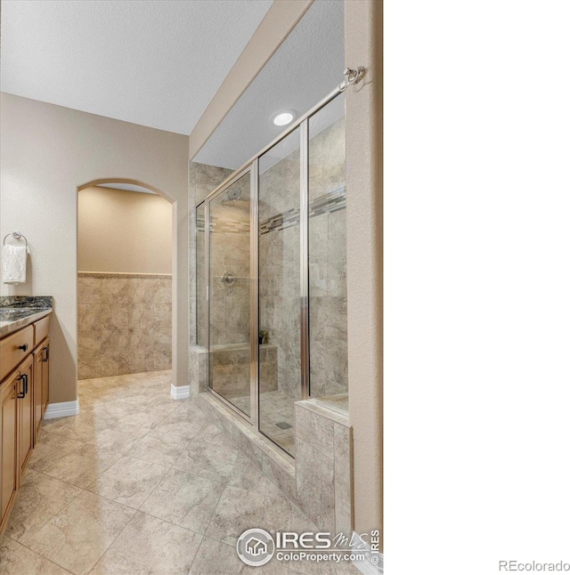 15002 Cosmos Way, Broomfield, CO 80023 - bathroom featuring vanity, a stall shower, and tile patterned flooring
