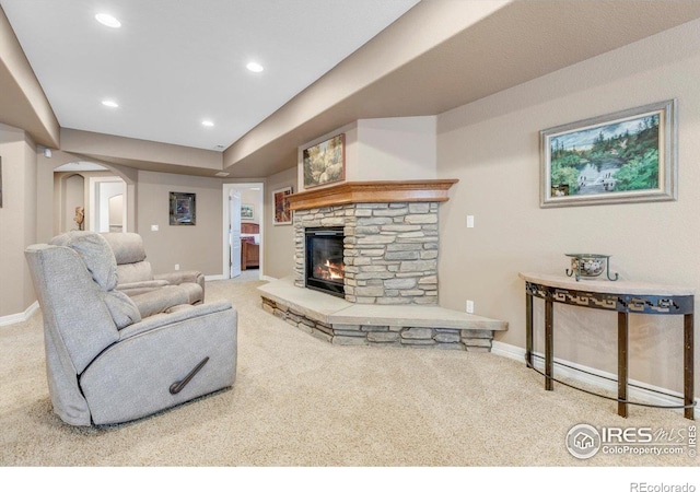 15002 Cosmos Way, Broomfield, CO 80023 - living area featuring carpet flooring, arched walkways, a stone fireplace, and recessed lighting