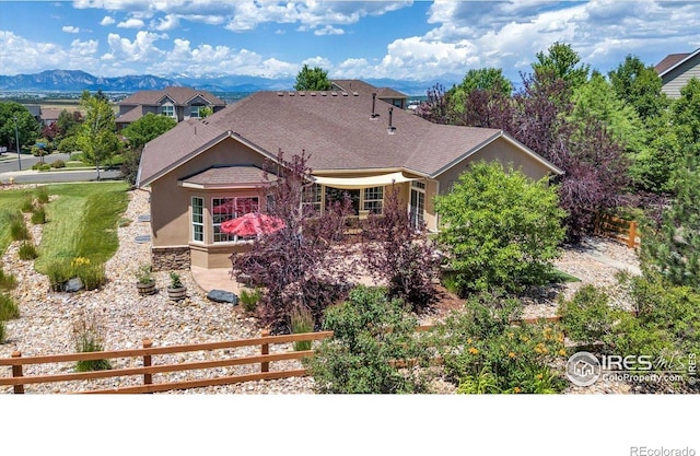 15002 Cosmos Way, Broomfield, CO 80023 - view of front of home featuring stucco siding, a mountain view, and stone siding