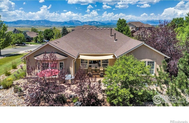 15002 Cosmos Way, Broomfield, CO 80023 - back of house with stucco siding, a mountain view, and a patio area