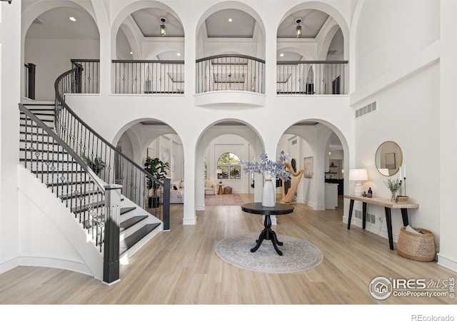 16636 Krameria Way, Brighton, CO 80602 - entrance foyer featuring stairway, a towering ceiling, and wood finished floors
