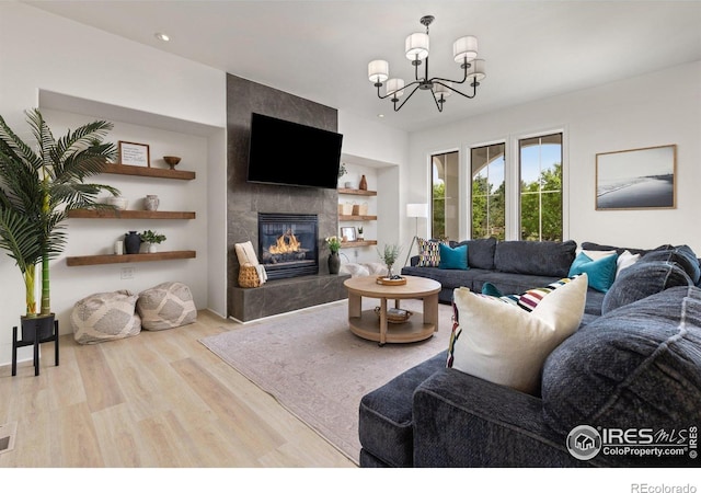 16636 Krameria Way, Brighton, CO 80602 - living area with wood finished floors, a fireplace, a chandelier, and recessed lighting