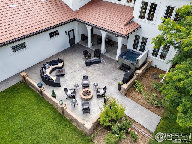 16636 Krameria Way, Brighton, CO 80602 - view of patio with an outdoor living space with a fire pit, a hot tub, and outdoor dining space