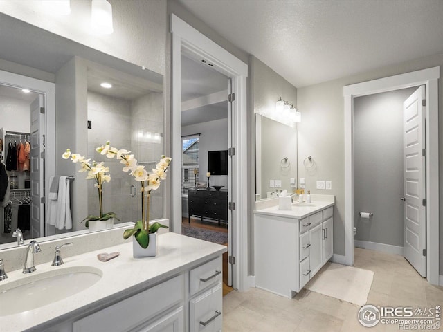 9035 S Shawnee Ct, Aurora, CO 80016 - bathroom with vanity, a shower stall, a walk in closet, and tile patterned floors