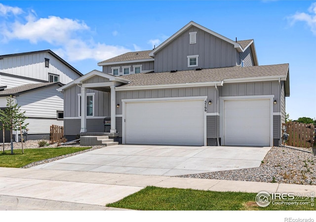 5766 Ranch St, Longmont, CO 80504 - view of front of house with board and batten siding, roof with shingles, and driveway